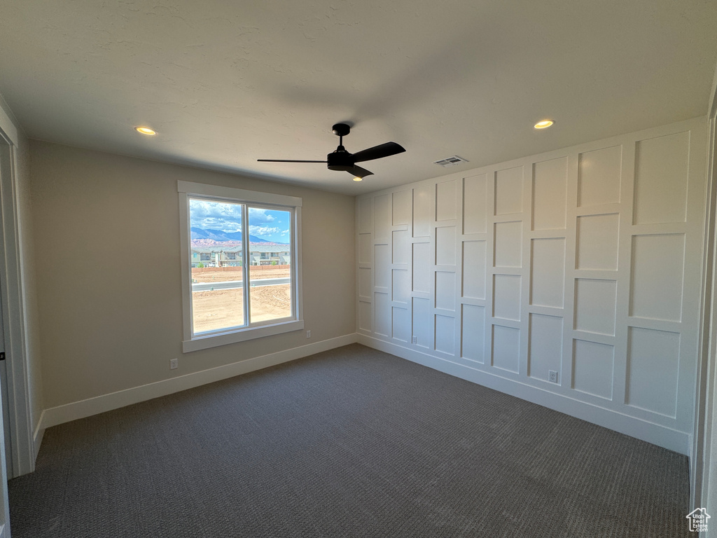 Unfurnished bedroom featuring dark colored carpet, baseboards, recessed lighting, and ceiling fan