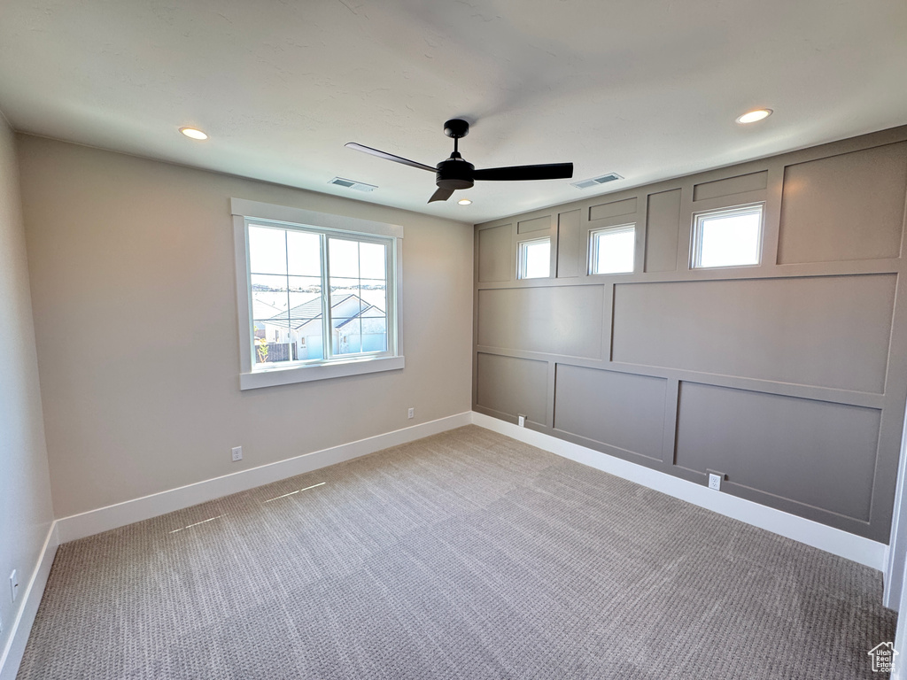 Empty room with a ceiling fan, baseboards, light colored carpet, and recessed lighting