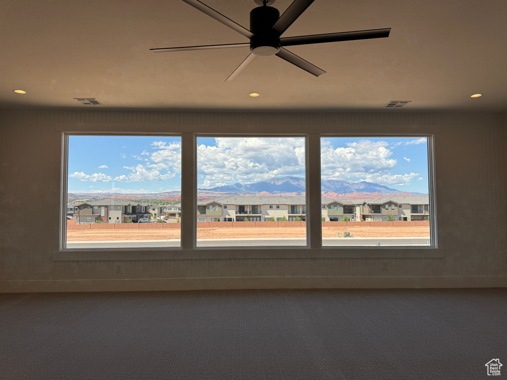 Unfurnished room featuring healthy amount of natural light, carpet floors, recessed lighting, and a ceiling fan