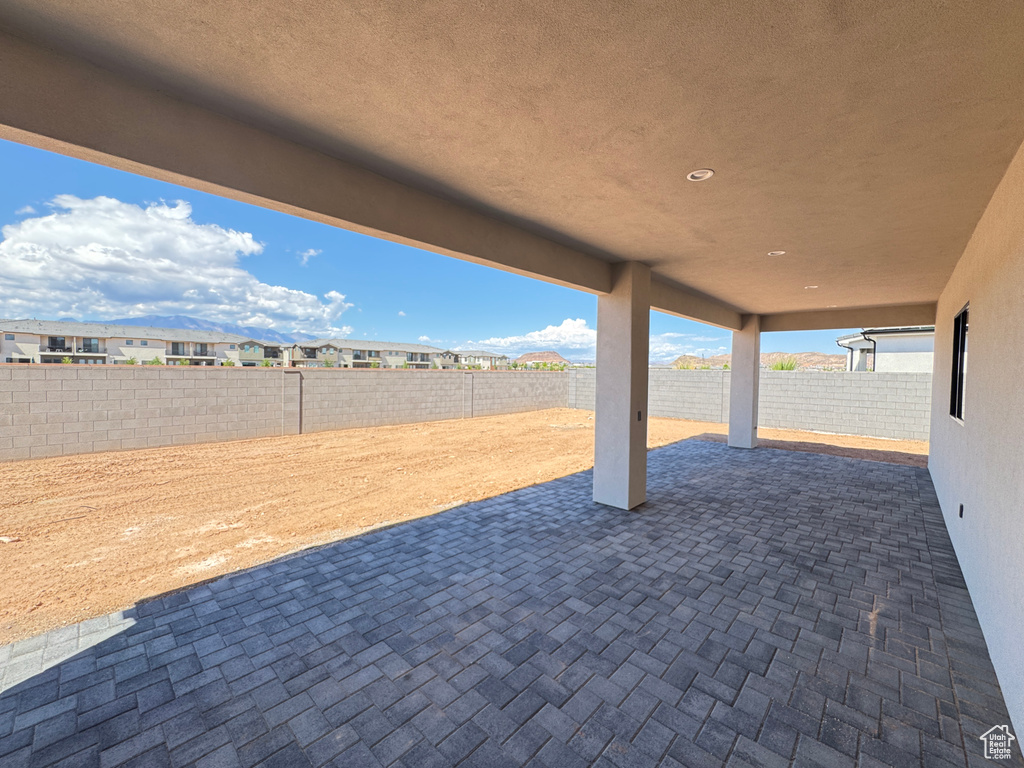 View of patio featuring a fenced backyard and a residential view