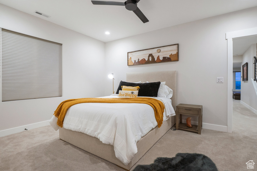 Carpeted bedroom with baseboards, ceiling fan, and recessed lighting