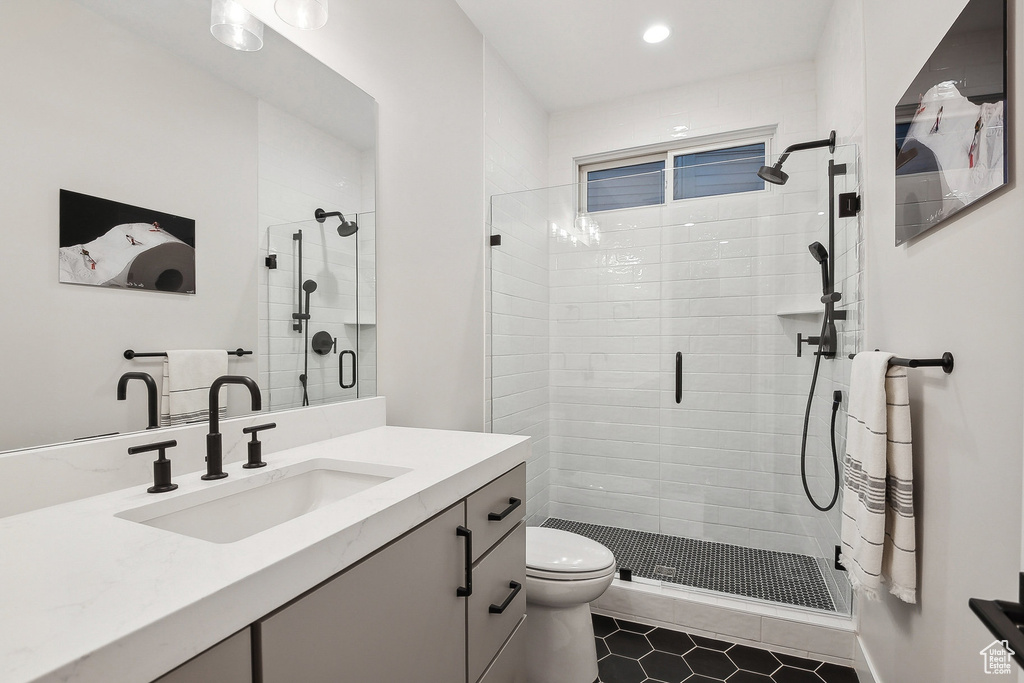 Bathroom with toilet, a shower stall, vanity, recessed lighting, and tile patterned floors