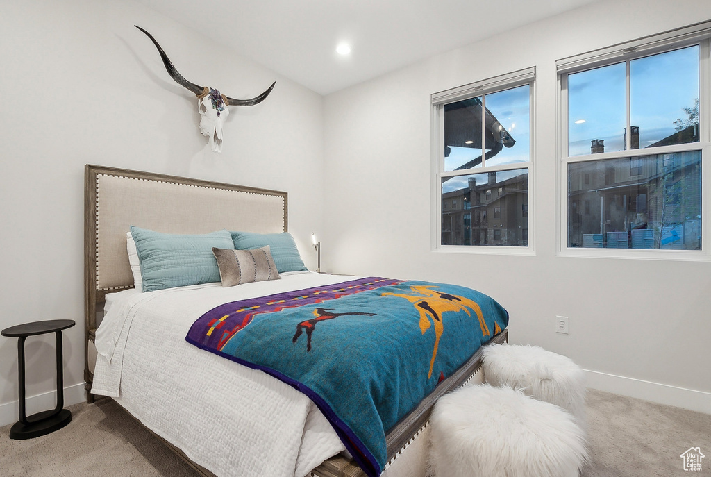 Carpeted bedroom featuring baseboards