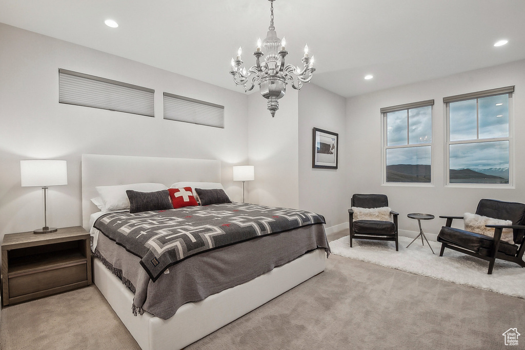 Carpeted bedroom with a chandelier, recessed lighting, and baseboards