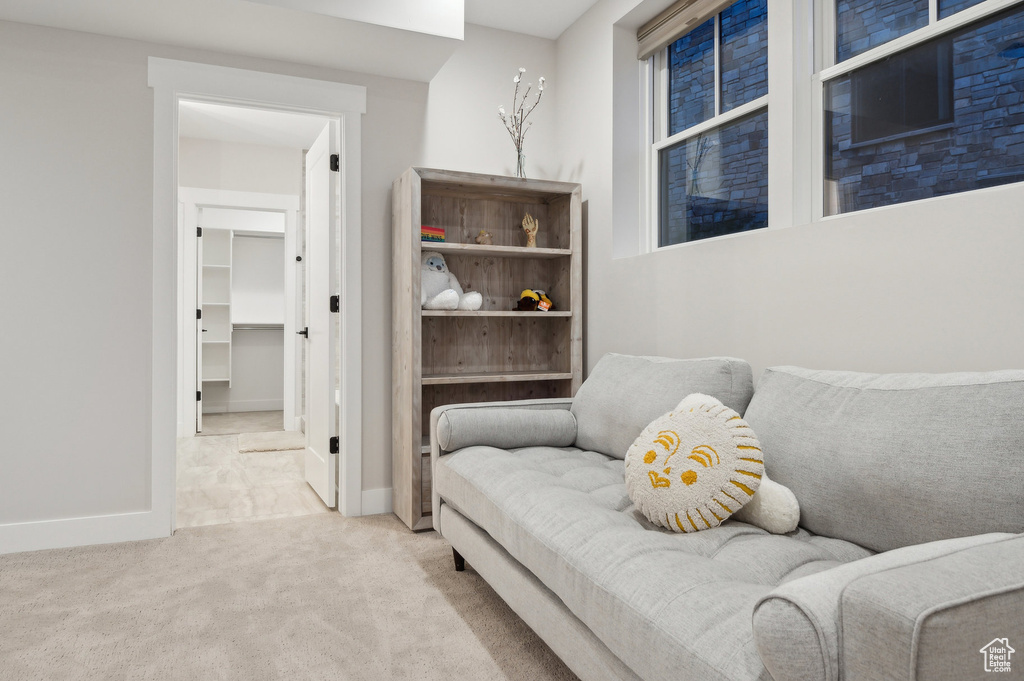 Sitting room featuring carpet flooring and baseboards