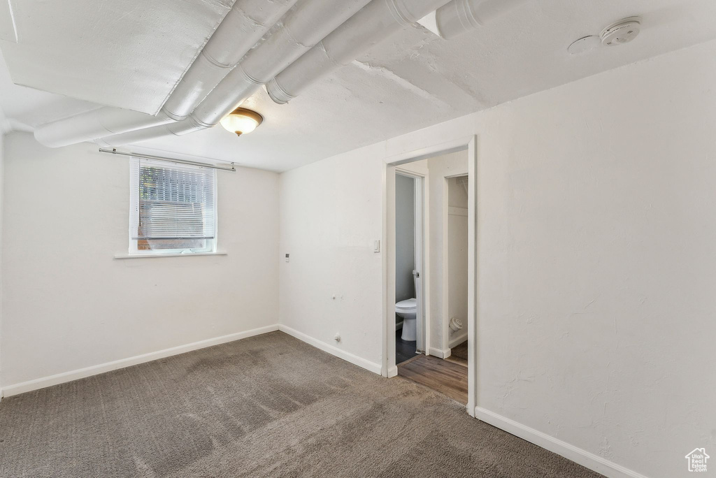 Unfurnished bedroom with baseboards and carpet flooring