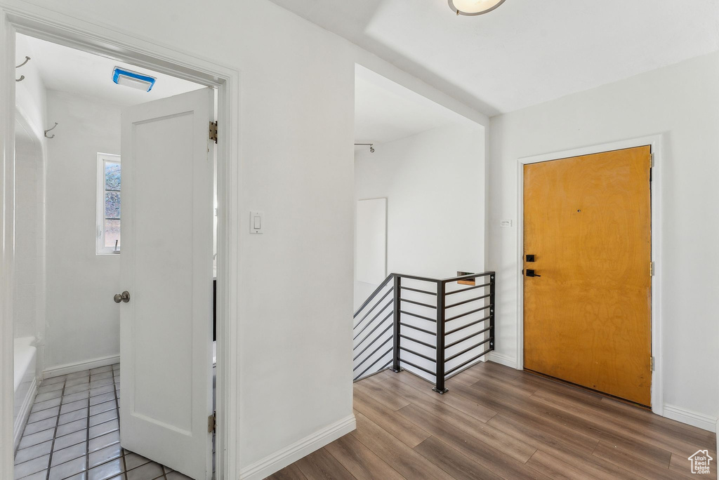 Foyer entrance featuring baseboards and wood finished floors