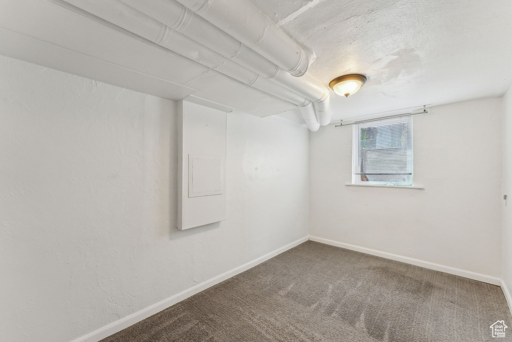 Basement with baseboards and carpet flooring