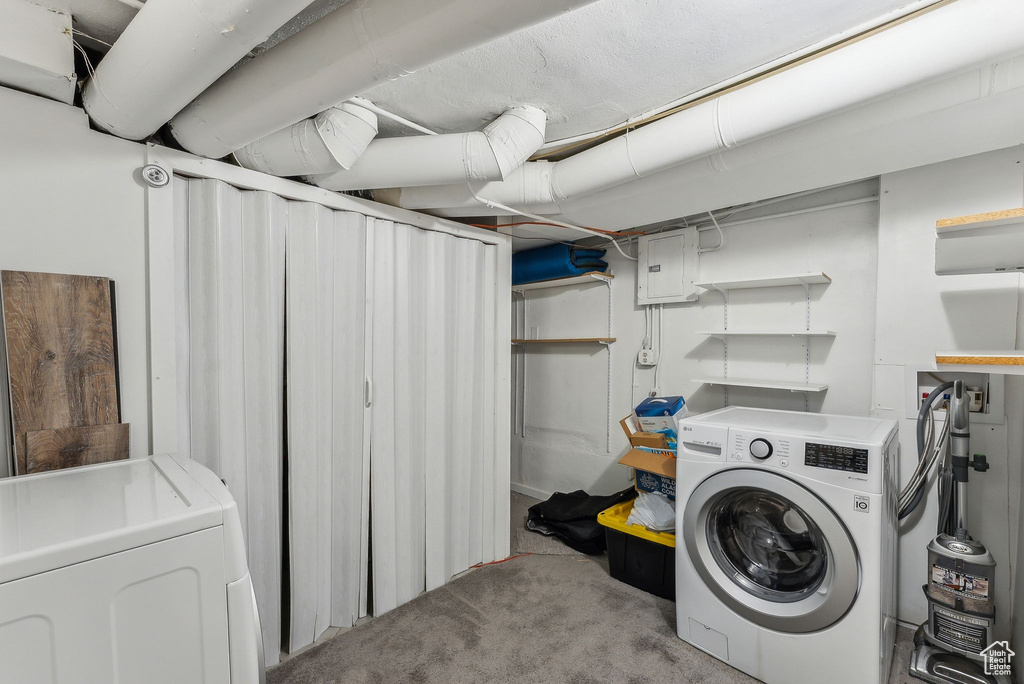 Laundry room featuring electric panel, carpet floors, laundry area, and washer and clothes dryer