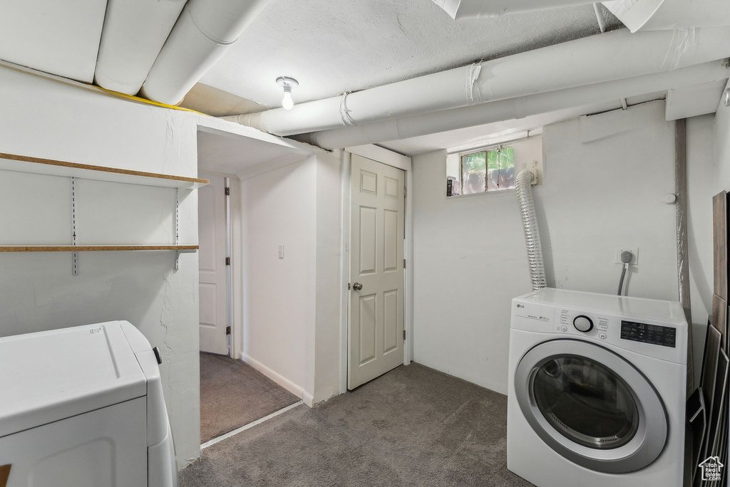 Laundry area featuring separate washer and dryer, laundry area, and carpet