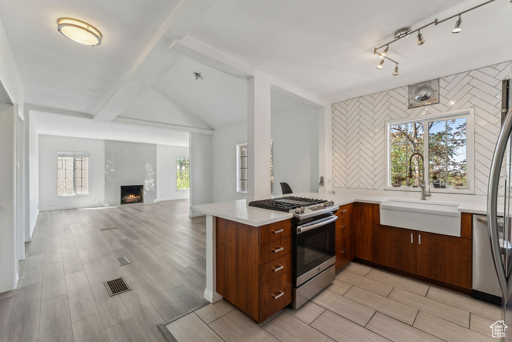 Kitchen featuring a sink, light wood-style floors, light countertops, stainless steel appliances, and visible vents