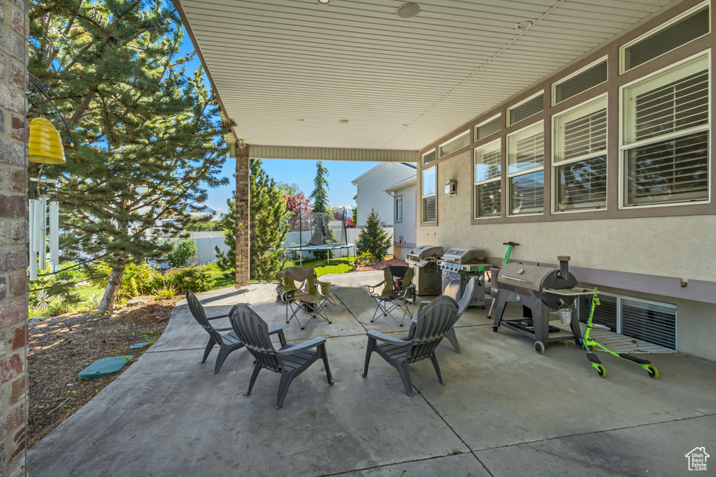 View of patio / terrace featuring a trampoline, fence, and area for grilling