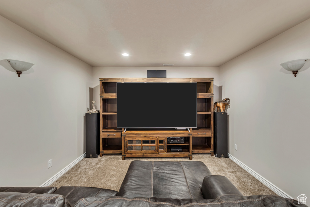 Carpeted living room featuring baseboards and recessed lighting