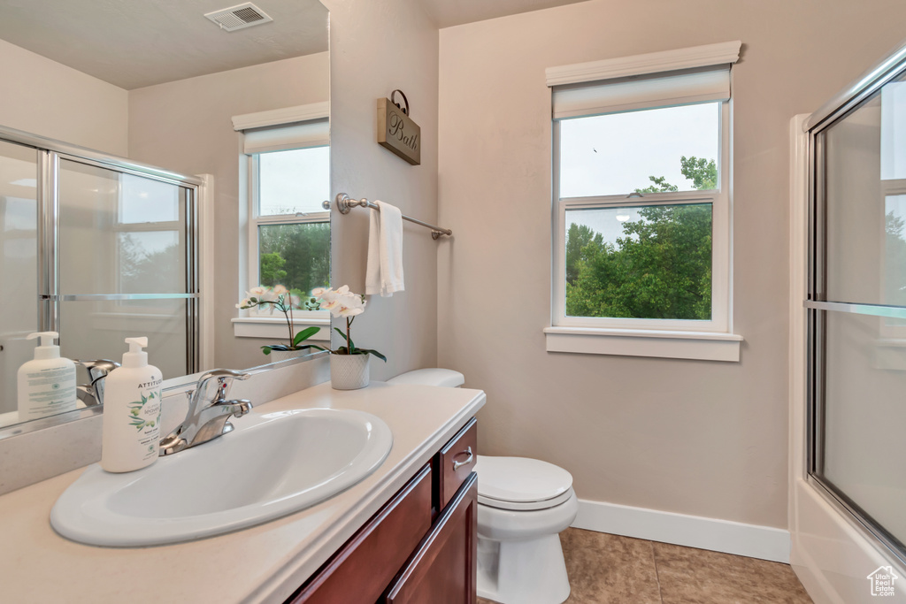 Full bathroom with a wealth of natural light, visible vents, and vanity