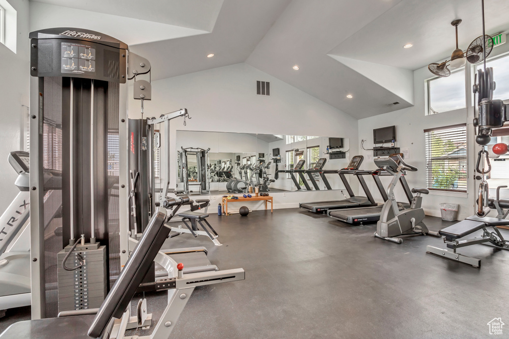 Workout area featuring high vaulted ceiling and recessed lighting