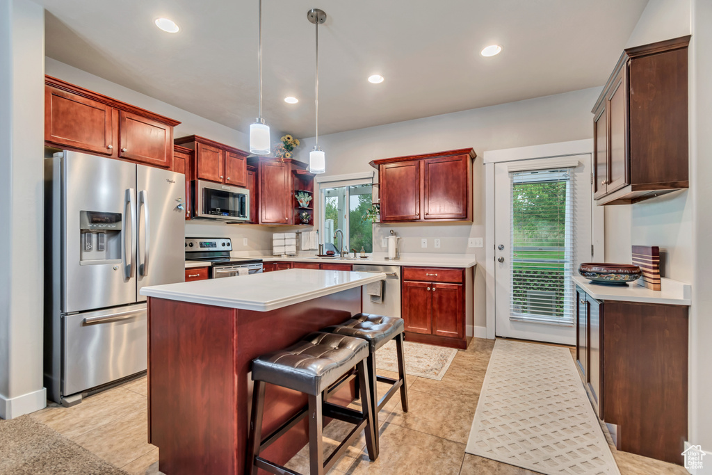 Kitchen featuring a sink, a wealth of natural light, light countertops, and appliances with stainless steel finishes
