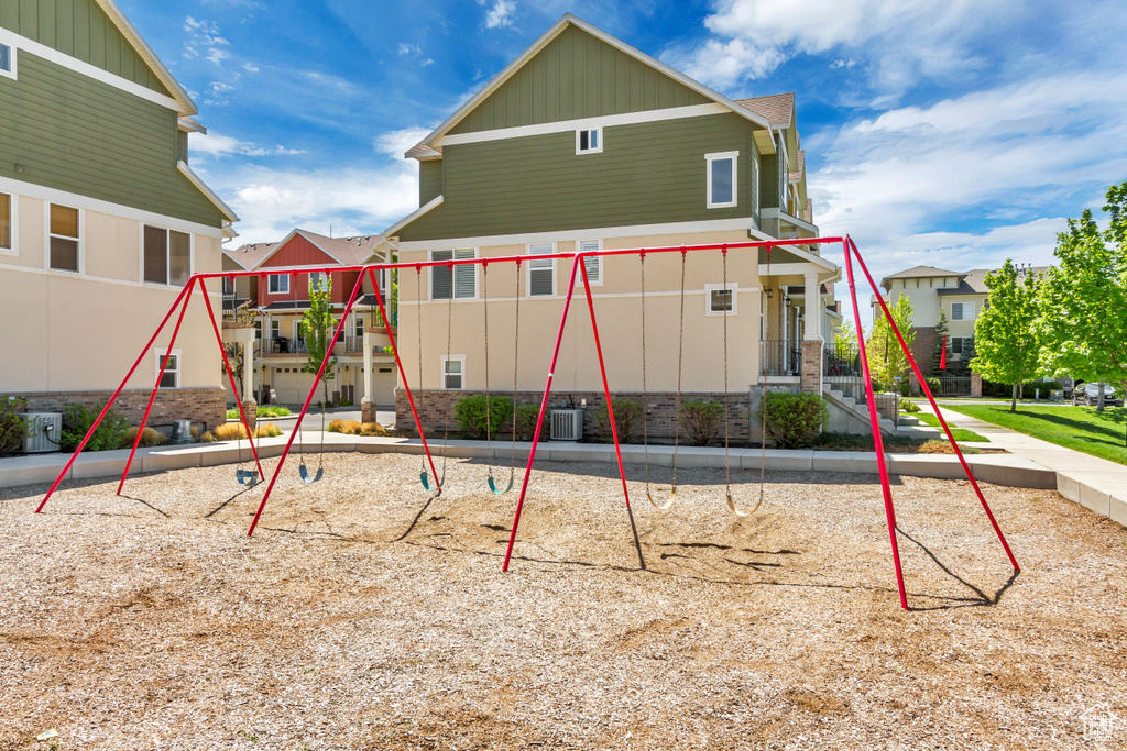 View of playground featuring a residential view and central air condition unit