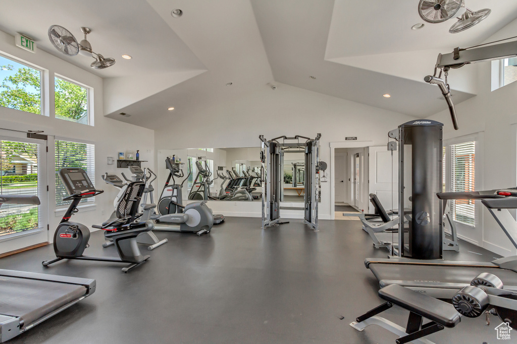 Gym with high vaulted ceiling, recessed lighting, and baseboards