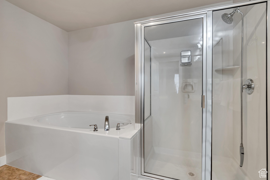 Full bathroom featuring a bath and a stall shower