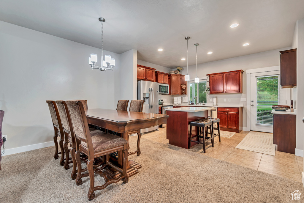 Dining room featuring recessed lighting, a wealth of natural light, baseboards, and a notable chandelier