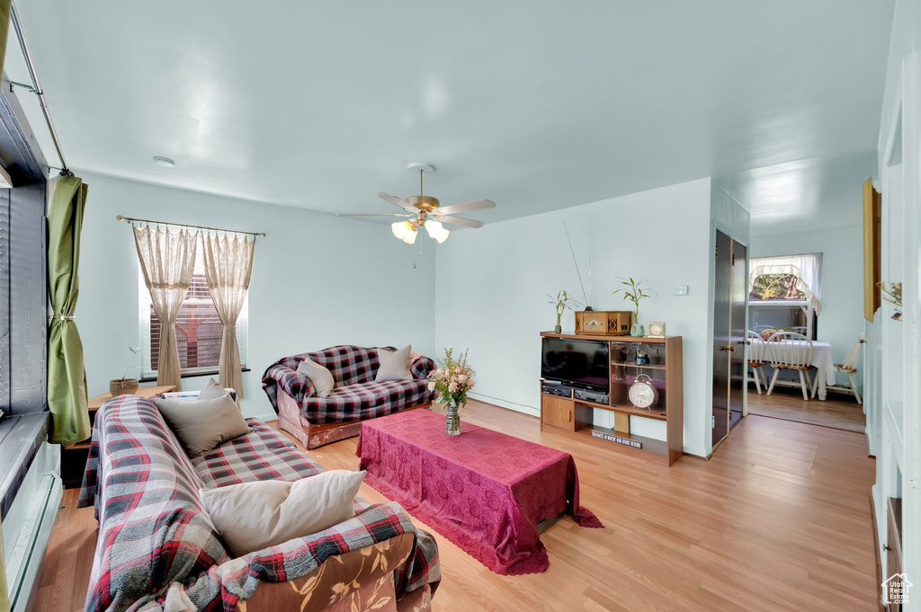 Living room featuring light wood finished floors and a ceiling fan
