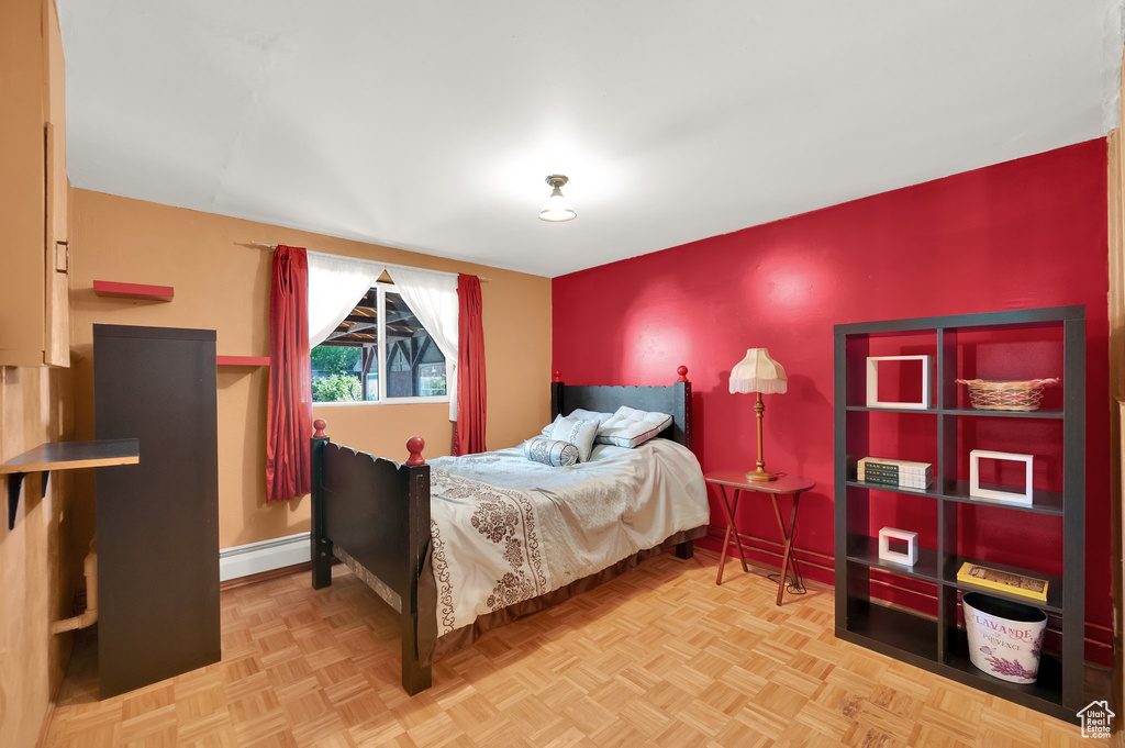 Bedroom with baseboards and a baseboard radiator