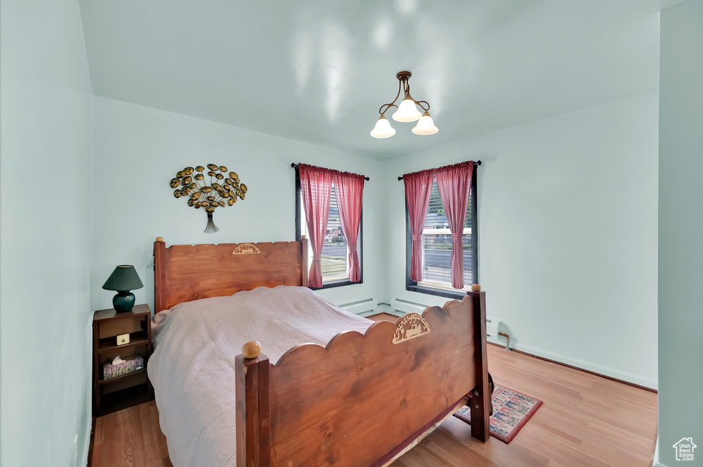 Bedroom featuring wood finished floors and baseboards