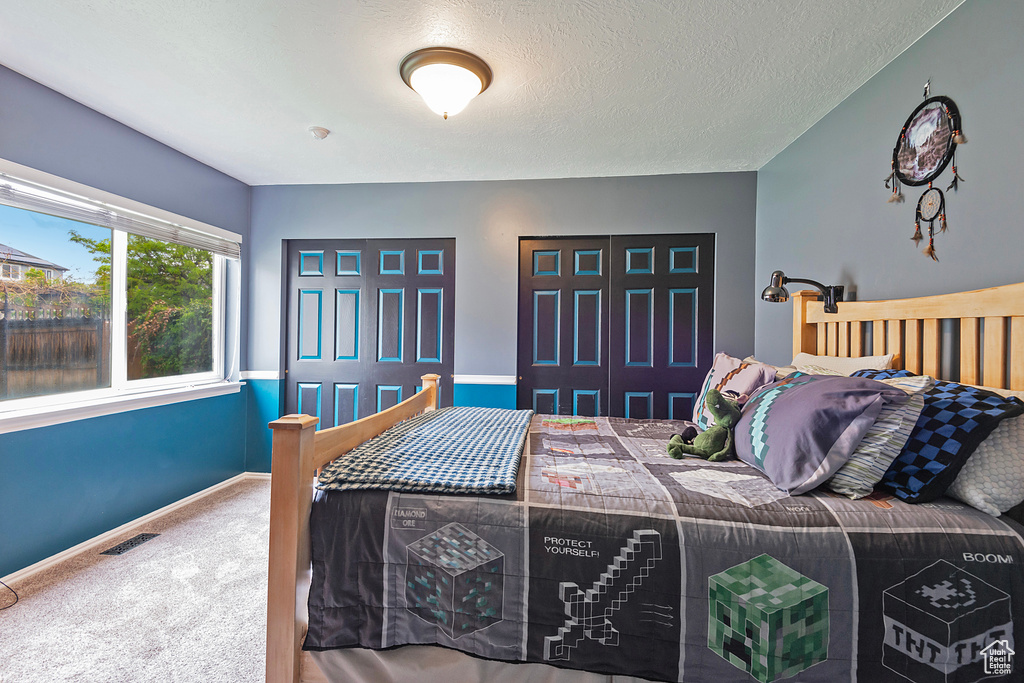 Bedroom featuring baseboards, visible vents, and carpet floors