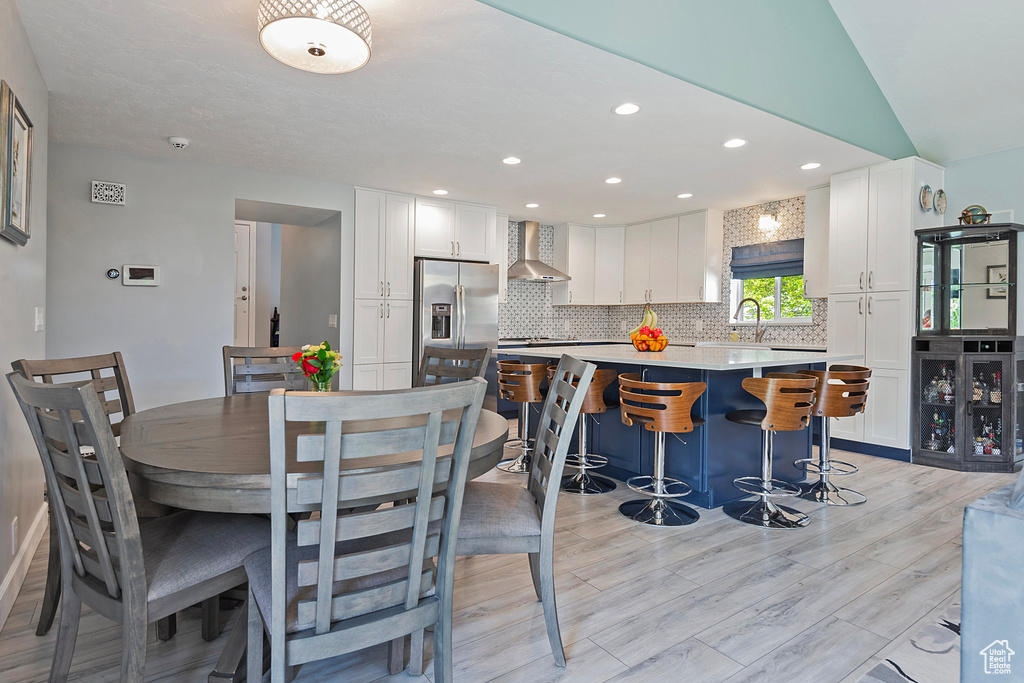 Dining area featuring light wood finished floors and recessed lighting