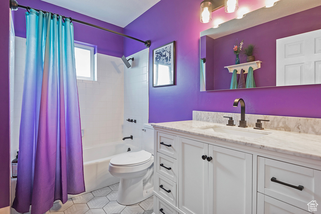 Full bathroom with shower / tub combo with curtain, vanity, toilet, and tile patterned flooring