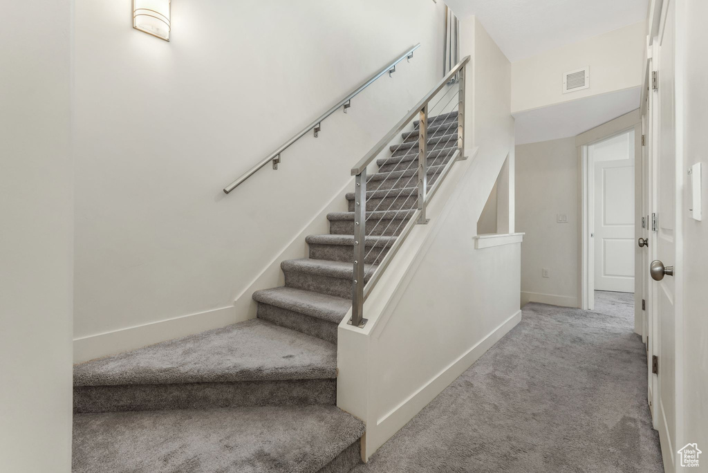 Stairs featuring carpet flooring and baseboards