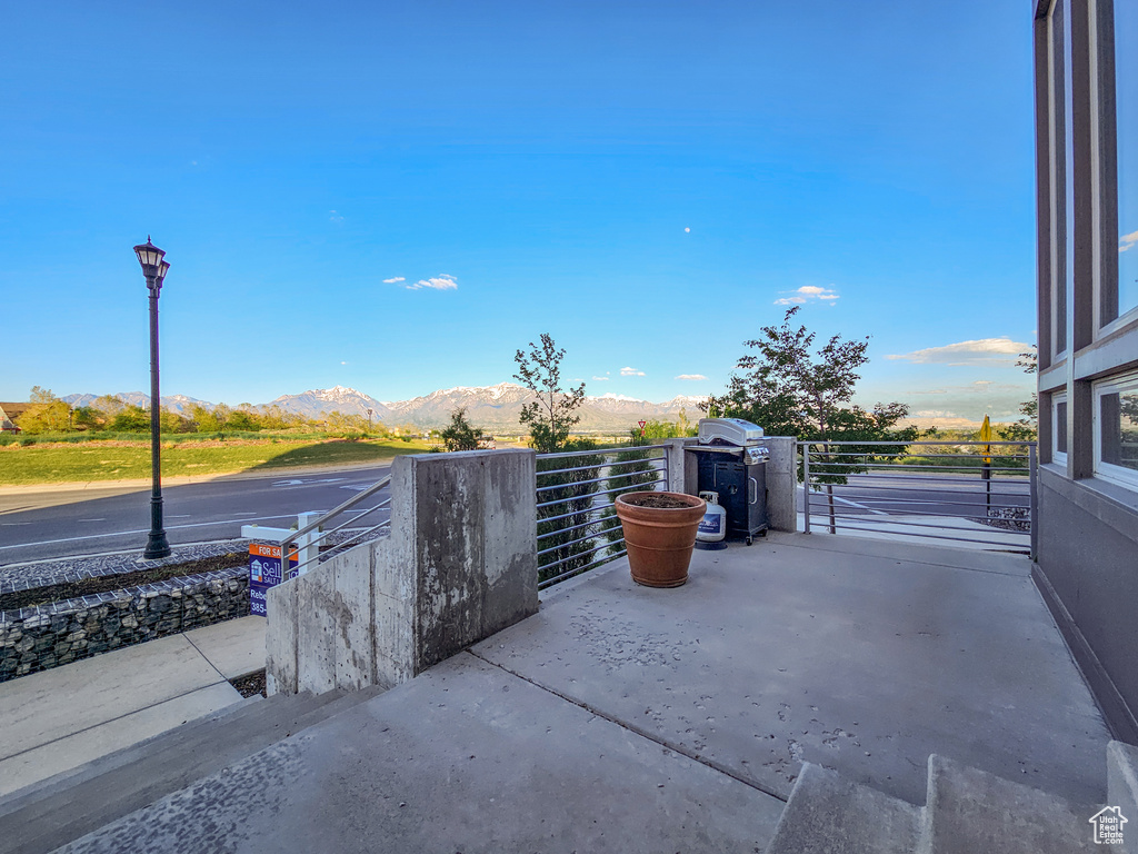 View of patio with a mountain view and a grill