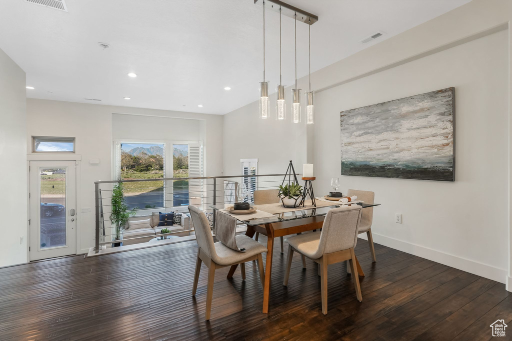 Dining space with dark wood-type flooring, recessed lighting, and baseboards