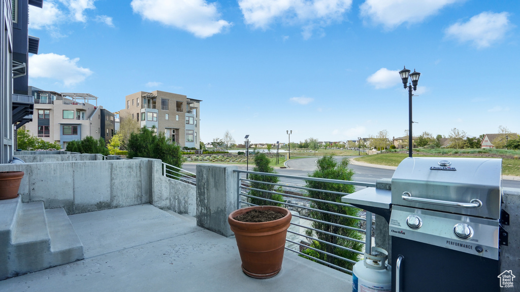 View of patio with area for grilling and a residential view
