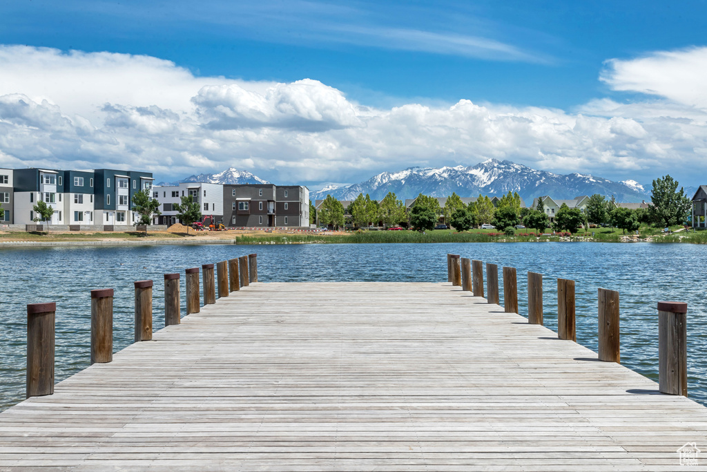 Dock featuring a water and mountain view and a residential view