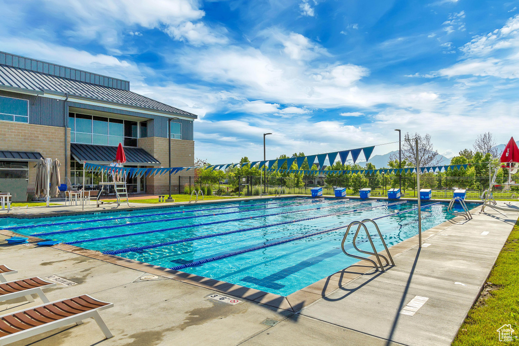 Community pool with fence and a patio