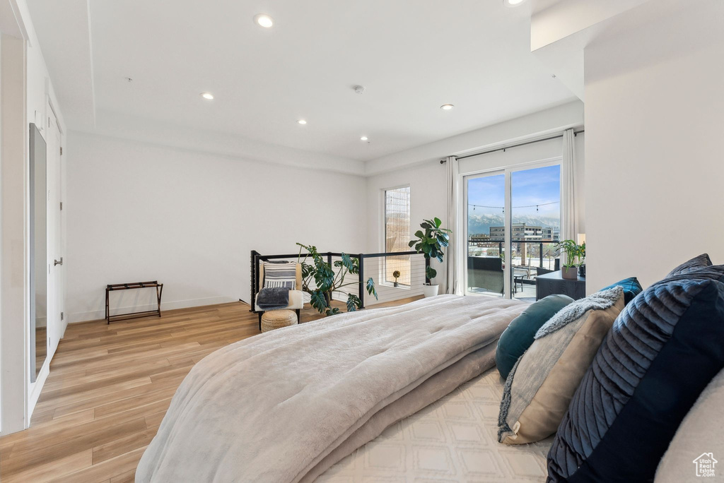Bedroom featuring access to outside, light wood finished floors, recessed lighting, and baseboards
