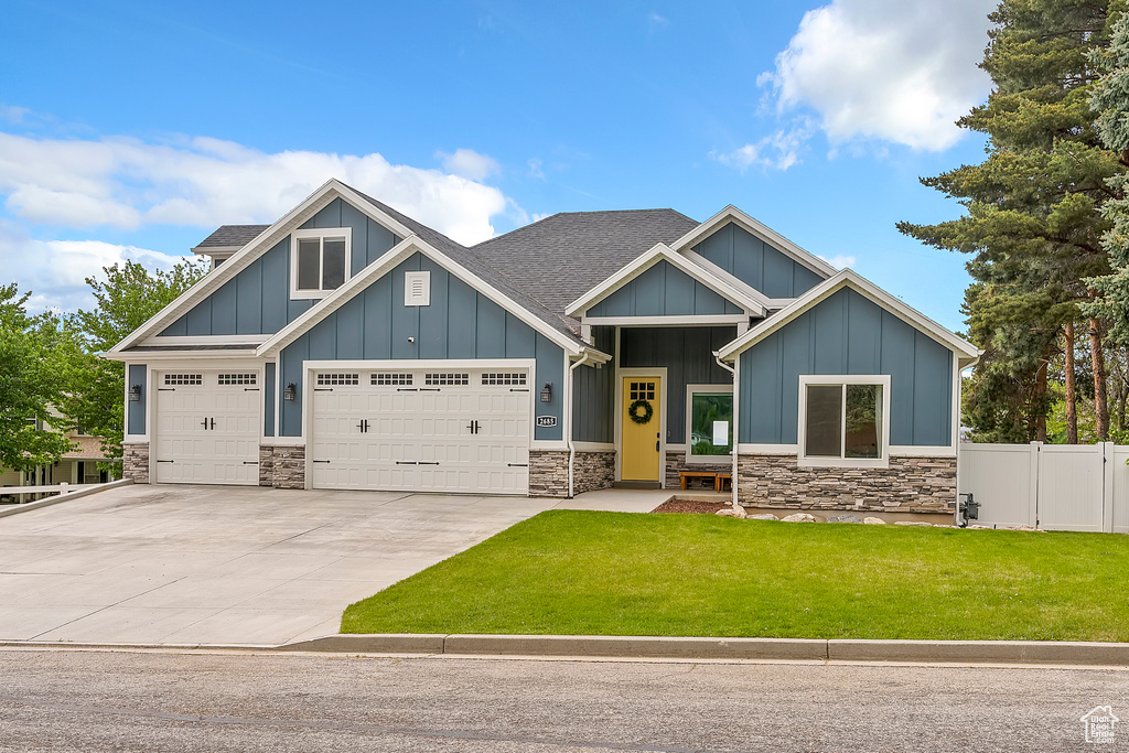 Craftsman inspired home featuring board and batten siding, stone siding, and a shingled roof