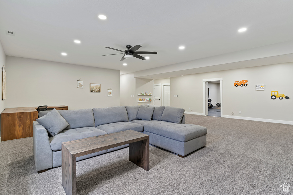 Living area featuring carpet flooring, recessed lighting, a ceiling fan, and baseboards