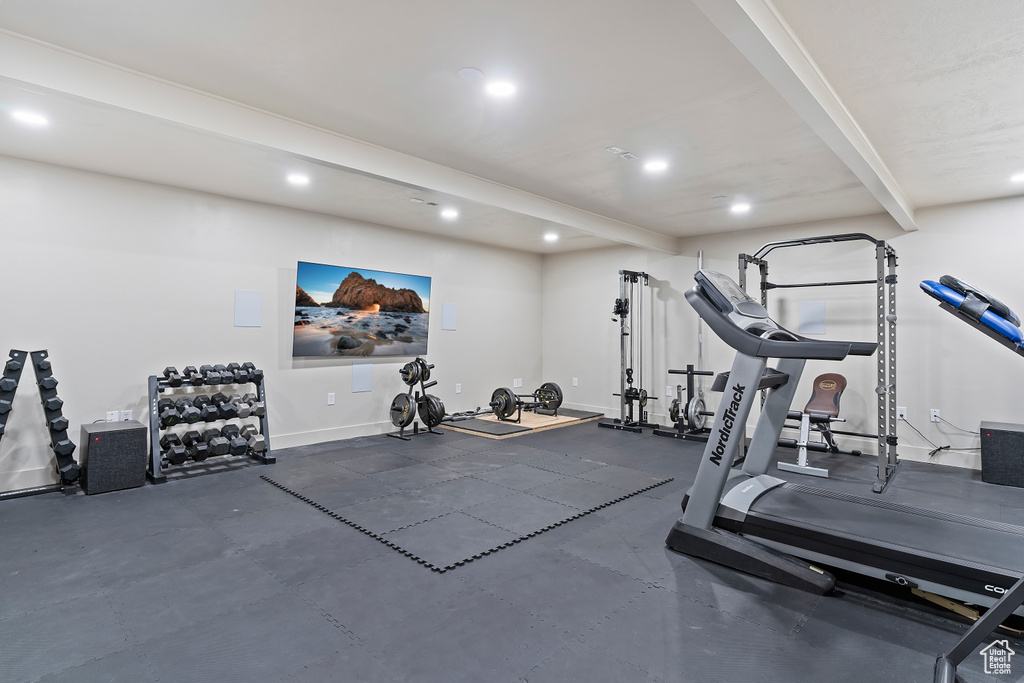 Exercise area with recessed lighting and baseboards