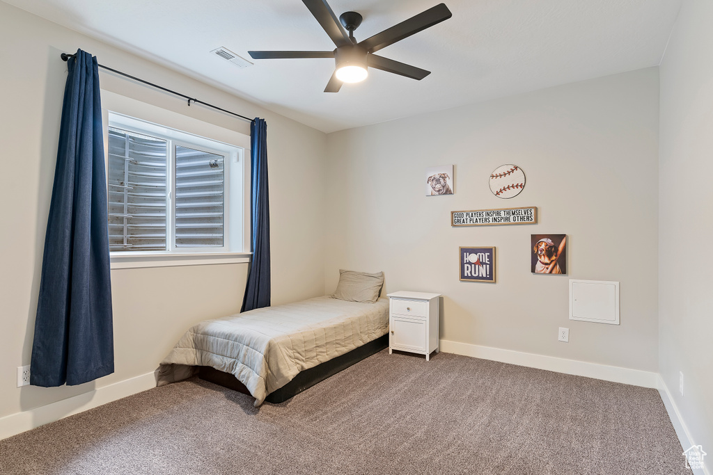 Carpeted bedroom with baseboards and a ceiling fan