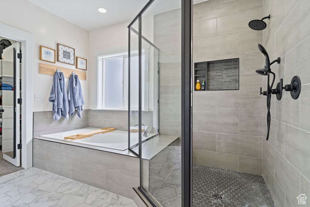 Full bathroom with a stall shower, a garden tub, and recessed lighting