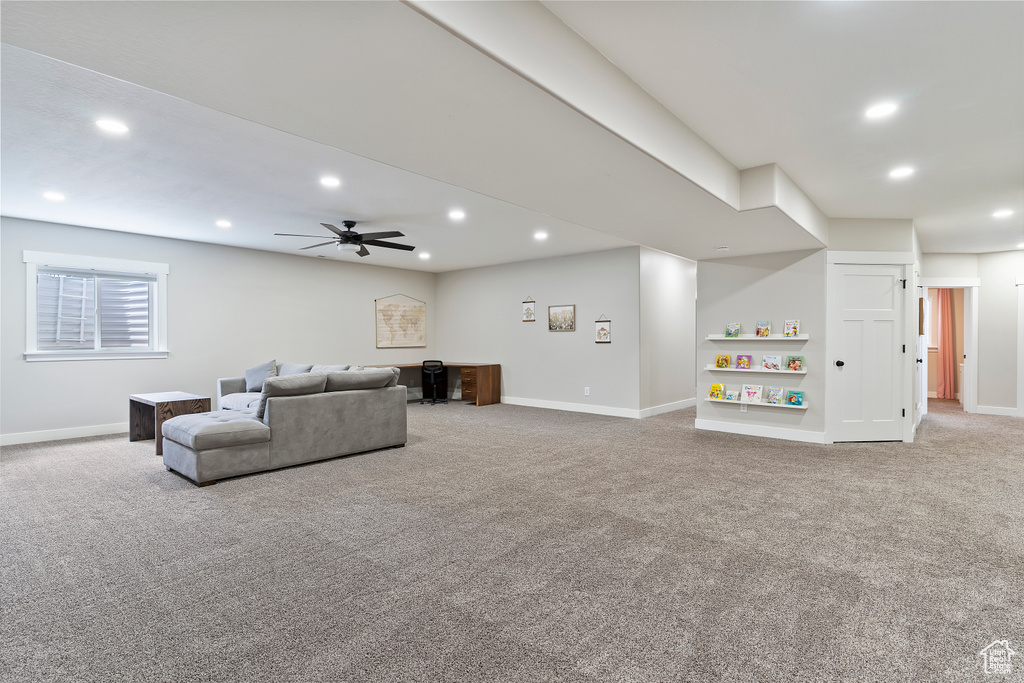 Living room featuring carpet floors, recessed lighting, ceiling fan, and baseboards