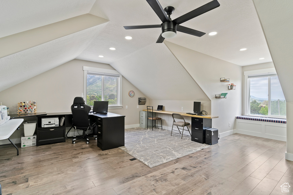 Office with wood finished floors, ceiling fan, lofted ceiling, recessed lighting, and baseboards