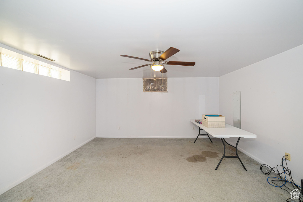 Unfurnished office featuring carpet, a ceiling fan, and baseboards