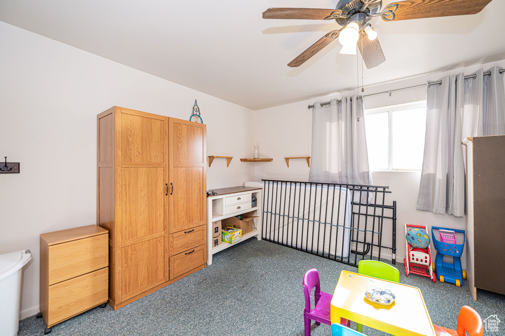 Rec room with ceiling fan and carpet