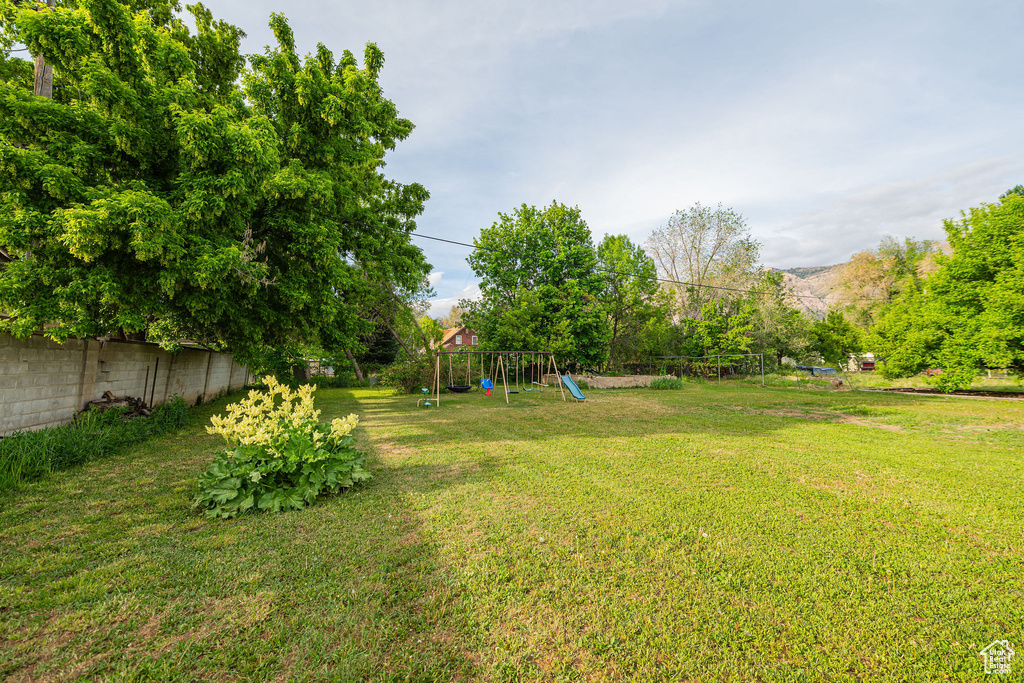 View of yard with a playground and a mountain view