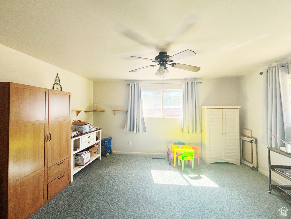 Rec room with a ceiling fan and carpet flooring