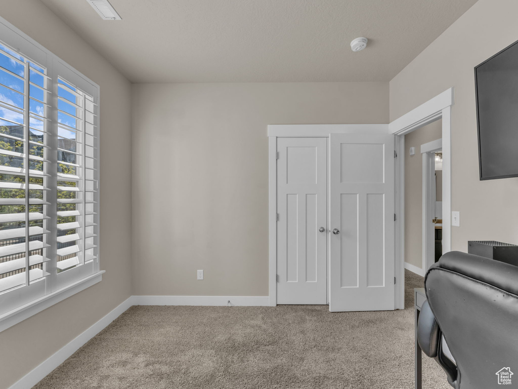 Carpeted office space with baseboards