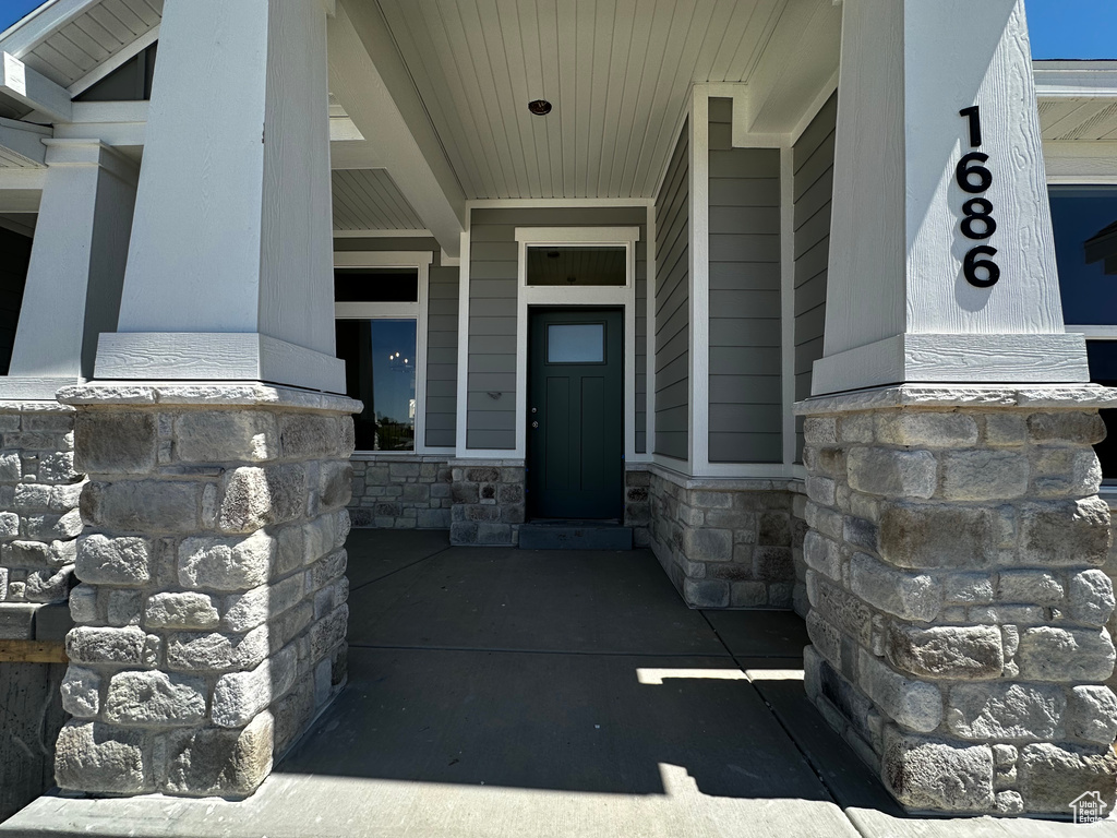 View of exterior entry featuring stone siding